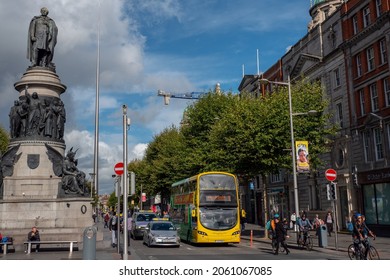 Dublin, Ireland - 02.10.2021: O'Connell Street, Busy Capital Traffic, The Spire Of Needle In The Background. Warm Sunny Day