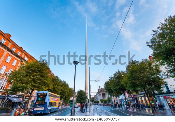 Dublin, Ireland - August 2019: The Spire of\
Dublin, alternatively titled the Monument of Light, a large,\
stainless steel, pin-like monument located on O\'Connell Street\
during a busy afternoon