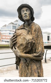 Dublin, Ireland - August 7, 2017: Great Irish Famine Bronze Statue Set On Custom House Quay Along Liffey River In Docklands. One Slender Male Figure.