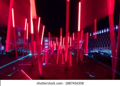 Dublin, Ireland - December 2020 : Red Lights At The Front Of Bord Gáis Energy Theatre In Dublin Docklands Area. Abstract Concept With Lights Blurred By Zooming During A Long Exposure.