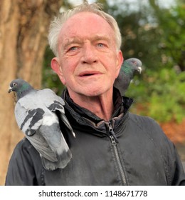 Dublin, Dublin / Ireland - December 30 2017: Photos Of An Unnamed Man Working To Raise Money For The Simon Community In Dublin By Allowing Tourists To Feed The Pigeons In St Stephens Green In Dublin