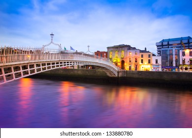 Dublin Ireland at dusk with waterfront and historic Ha'penny Bridge