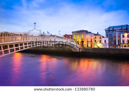 Dublin Ireland at dusk with waterfront and historic Ha'penny Bridge