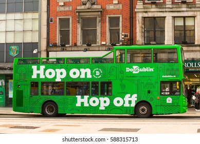 Dublin, Ireland - February 13, 2017: Green city bus with an open top is great for exploring Dublin on a hop-on hop-off city 24 or 48 hours ticket duration bus tour. 