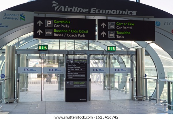 DUBLIN, IRELAND - JANUARY 15, 2020:\
The exit from Terminal 2 in Dublin Airport with pedestrian passage\
to car parks, bus and coach park, car rental and\
taxis.