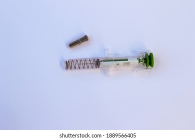 Dublin, Ireland - January 2021: Used Injection Syringe Needle With Safety Spring Needle Guard And Protective Cap For Safe Sharps Disposal 