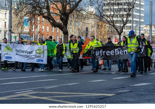 Dublin,\
Ireland  January 26 2019. Yellow vest movement in Dublin city\
centre. Group of protestants of all ages   marching with banners\
escorted by police in a peaceful \
manifestation