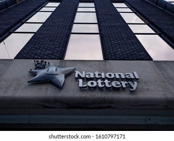 DUBLIN, IRELAND - JANUARY 8, 2020: Low Angle Shot Of The National Lottery Logo, With Building Facade Above. It's The Irish National Lottery Building On Abbey Street Lower In Dublin City Center.