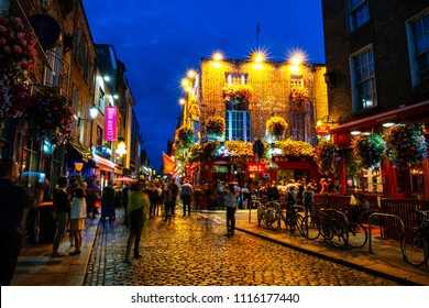 DUBLIN, IRELAND - JULY 19, 2017: Nightlife At Popular Historical Part Of The City - Temple Bar Quarter In Dublin, Ireland. The Area Is The Location Of Many Bars, Pubs And Restaurants