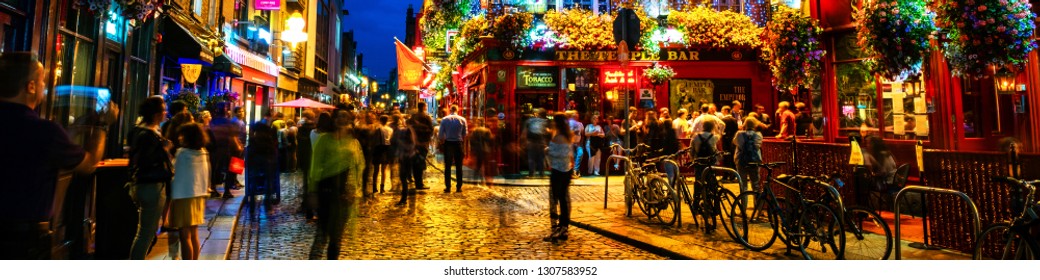 DUBLIN, IRELAND - JULY 19, 2017: Nightlife at popular historical part of the city - Temple Bar quarter in Dublin, Ireland. The area is the location of many bars, pubs and restaurants