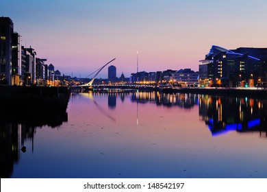 DUBLIN, IRELAND - JULY 22: Night skyline of the Dublin City Center on July 22, 2013 in Dublin, Ireland. Samuel Beckett Bridge on the river Liffey was designed by architect Santiago Calatrava