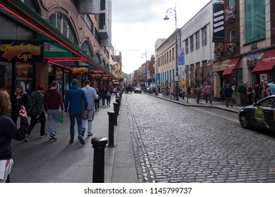 Dublin, Ireland - July 7th 2017: Tourists And Local People Walking Along Cobbled Street In Temple Bar, Dublin, Ireland.