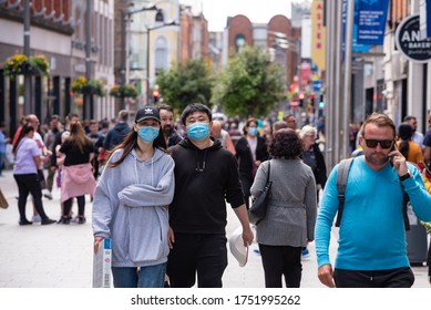 Dublin, Ireland - June 08 2020: Couple Walking On Street With Protective Masks During Covid 19 Lockdown