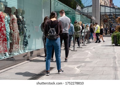 Dublin, Ireland - June 08 2020: Long Line Of People Queueing Outside Of A Clothing Shop On King Street  Mantaining Social Distance During Coronavirus COVID-19 Lockdown