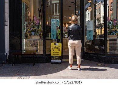 Dublin, Ireland - June 08 2020: Woman Waiting For Her Turn Outside Of Coffee Shop During Covid 19 Lockdown