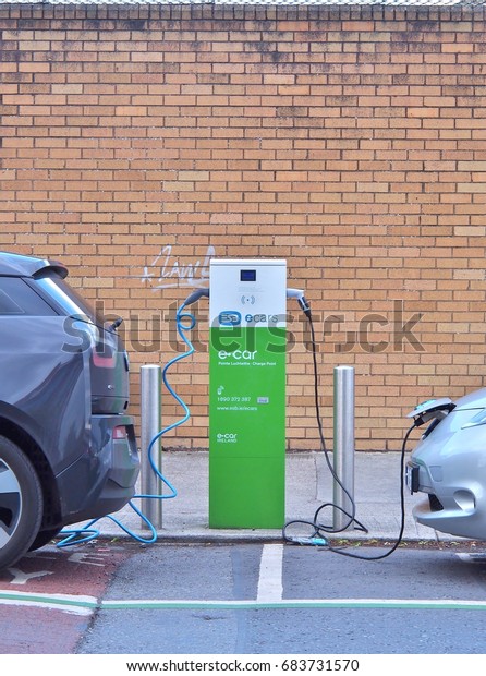 Dublin, Ireland - June 3, 2017: Electric Vehicle\
\'EV\' charging electric power in battery at public charge point.\
Ecars operates and maintains 1,200 public charge points across the\
island of Ireland.