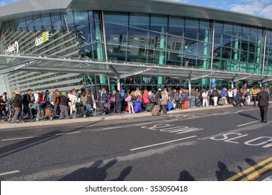 DUBLIN, IRELAND - JUNE 9, 2012: Travellers Queue Outside Airport Building After Stranded For A While Due To A False Alarm AtDublin Airport, Ireland