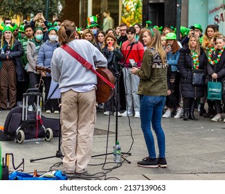 Dublin, Ireland - March 17 2022: Singers Allie Sherlock and Zoe Clarke perform to the crowds on Dublin's Grafton Street after the St. Patrick's Day parade. EDITORIAL USE