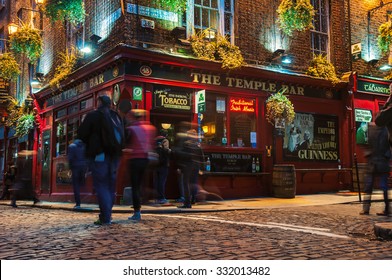 DUBLIN, IRELAND - NOVEMBER 11, 2014: Nightlife At Popular Historical Part Of The City - Temple Bar Quarter. The Area Is The Location Of Many Bars, Pubs And Restaurants. People Walking Inside A Pub