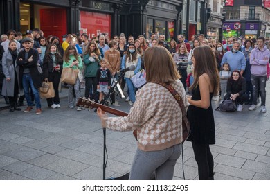 Dublin, Ireland - October 10 2021

Buskers Allie Sherlock and Saibh Skelly perform to a large crowd outside Brown Thomas on Dublin's Grafton Street celebrating the easing of lockdown restrictions 
