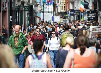 DUBLIN - JUL 22: Crowds of people walk on Grafton Street on Jul 22, 2015 in Dublin, Ireland. The street is a main tourist attraction in the Irish capital, renowned for its lively atmosphere and shops.