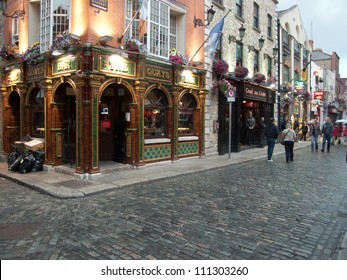DUBLIN - JUL 27: Unidentified people walk by many bars and pubs in famous Temple Bar quarter on Jul 27, 2009 in Dublin, Ireland. Temple Bar has preserved medieval street pattern, with narrow streets.
