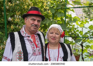 Dubossary, Transnistria, Moldova - june 20, 2021 : Moldovan man and woman in national costumes posing for tourists in Dubossary, Transnistria, Moldova, close up portrait
