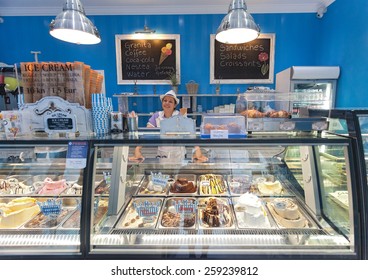 DUBROVNIK, CROATIA - MAY 26, 2014: Smiling young waitress at Gossip ice cream shop on main street Stradun. It is one of the best ice cream place in town popular among tourists.