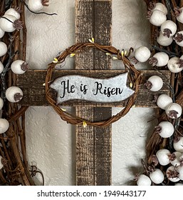 DUBUQUE, IOWA, April 4, 2021–Closeup Photo Of Wooden Cross In The Middle Of An Easter Grape Vine Wreath On Easter Sunday 2021.