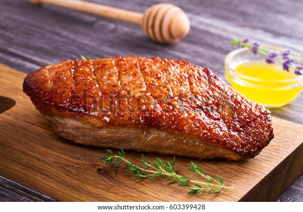 Duck breast, lavender honey and thyme, served on\
chopping board
