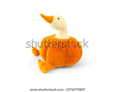 a duck doll in a pumpkin costume on a white background
