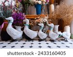 Duck figurine decoration in the garden. Family duck for decoration and many flower pots