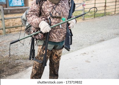 Duck Hunter In Camouflage With Shotgun And Hunting Gear. Copy Space.