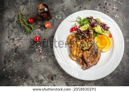 duck leg confit meat portion of prepared with baked potatoes, mushrooms and onions. banner, menu, recipe place for text, top view.