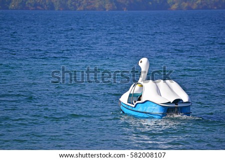 Duck pedal boat floating in Towada Lake, Akita Japan. Concept about loneliness and waiting for someone.Nature background with copy space for design work.Freedom and relaxing time for holiday