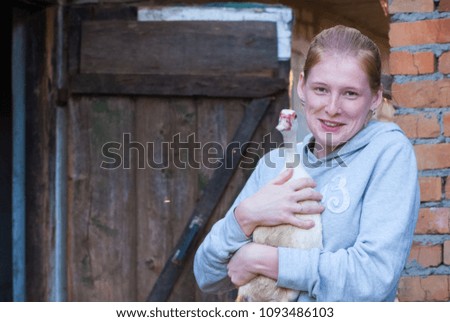 duck in woman hands outdoor on home yard