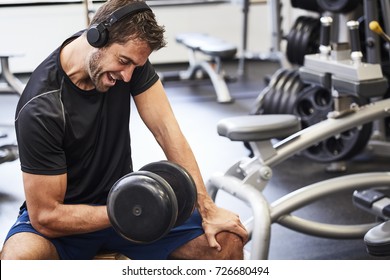 Dude Lifting Weight In Gym, Looking Down