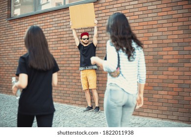 Dude with sign - man stands protesting things that annoy him