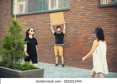 Dude with sign - man stands protesting things that annoy him - Shutterstock ID 1822011944