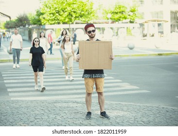 Dude with sign - man stands protesting things that annoy him - Shutterstock ID 1822011959