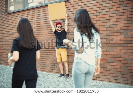 Dude with sign - man stands protesting things that annoy him