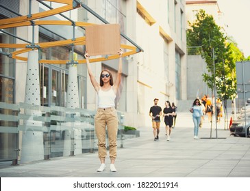 Dude with sign - woman stands protesting things that annoy her - Shutterstock ID 1822011914