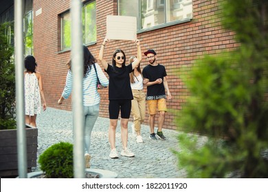 Dude with sign - woman stands protesting things that annoy her - Shutterstock ID 1822011920