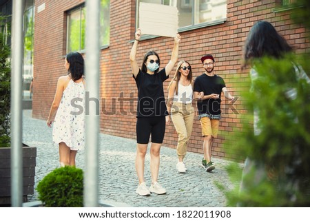 Dude with sign - woman stands protesting things that annoy her