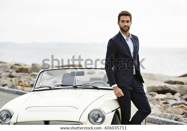 Dude in suit with cool\
car, portrait