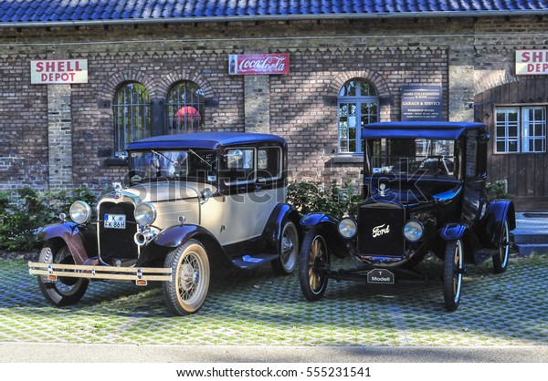 DUESSELDORF 1st OF\
AUGUST 2013 - TWO OLD FORD T - MODEL FROM 1915 AND ONE FROM 1926\
PARKING IN FRONT OF AN OLD\
GARAGE