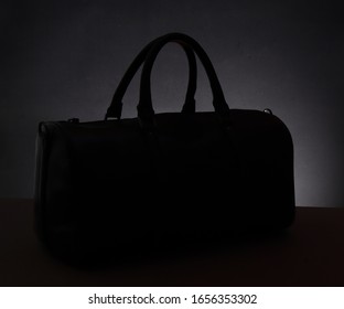 duffel bag silhouette on dark light background 
