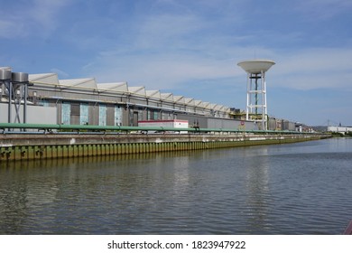 Duffel, Belgium - July 20, 2018; Pleasure yacht sails past the SIDAL aluminum factory on the Nete