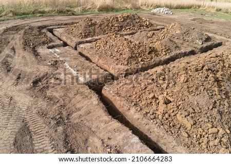 Dug out trench for building works of new house concrete foundation on construction site