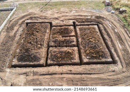 Dug out trench for building works of new house concrete foundation on construction site